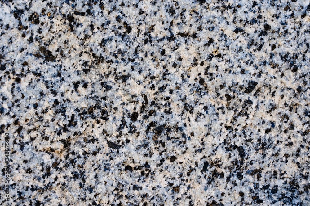 The texture of light pink natural granite with black spots