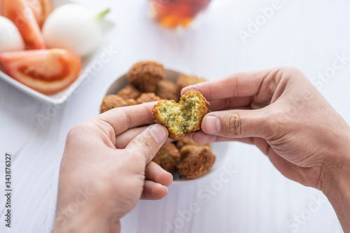 arab breakfast with hummus and falafel and fattah and foul on white wooden table Jordanian food 