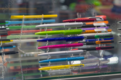 Multicolored plastic writing pens on the counter