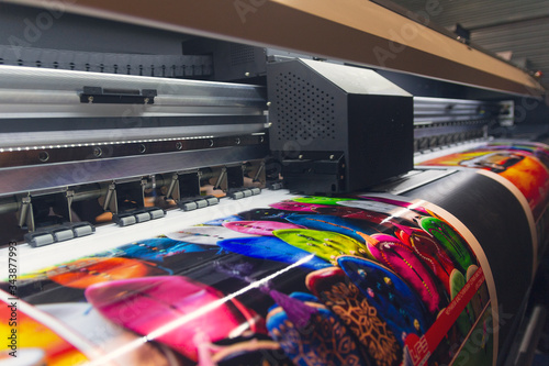 Canvas Print Large format printing machine in operation. Industry