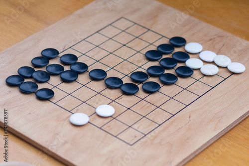 Chinese go game board  close up view of playing black and white stone pieces  Alphago