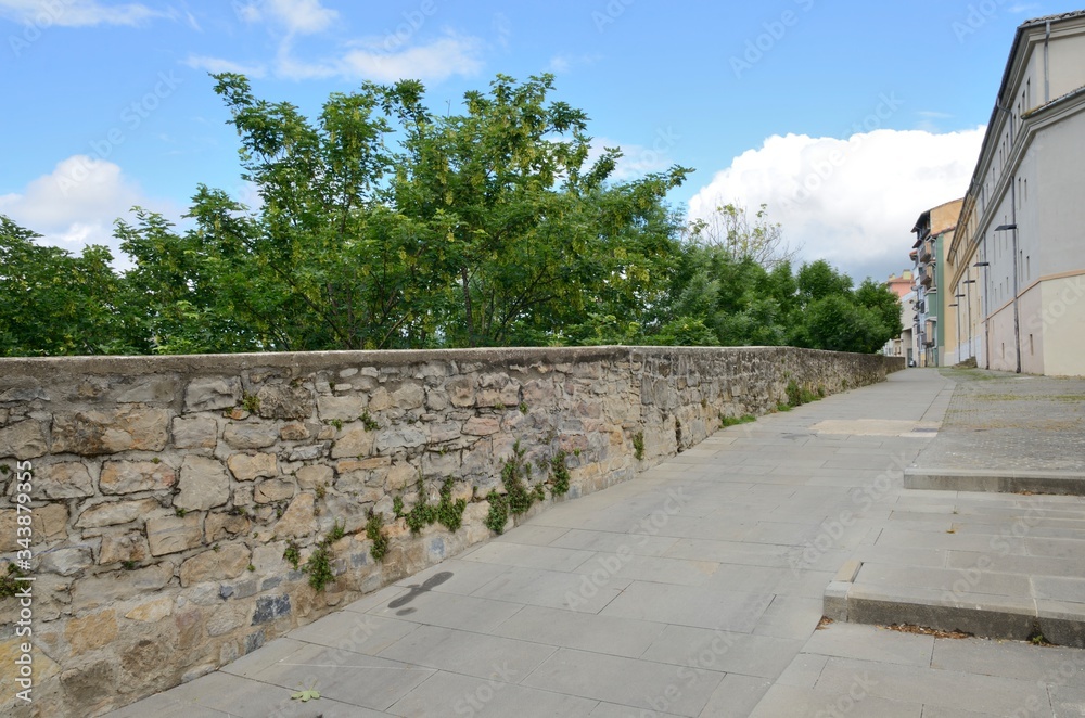 Footpath along stone wall in Pamplona, Spain