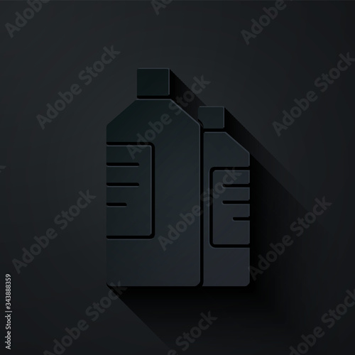 Paper cut Plastic bottles for laundry detergent, bleach, dishwashing liquid or another cleaning agent icon isolated on black background. Paper art style. Vector Illustration