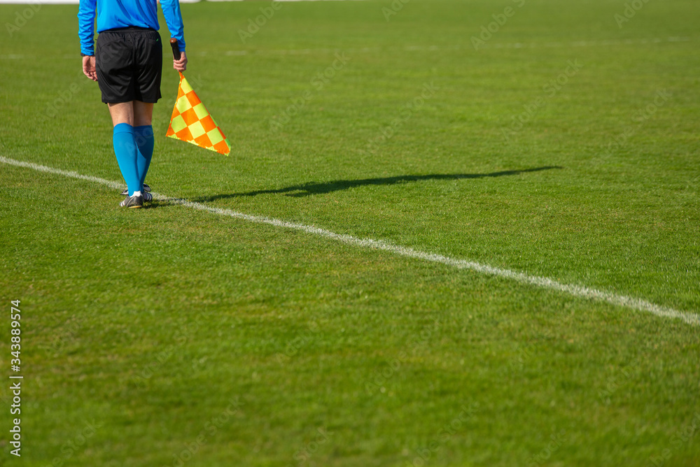 Assistant referee moving along the sideline during a soccer match