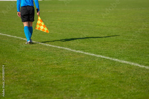 Assistant referee moving along the sideline during a soccer match