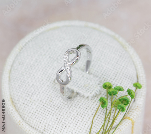 Konstfotografi beautiful infinity shape silver ring decorated with diamonds
