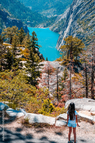 Asian girl looking over the vista into Donell Lake in California