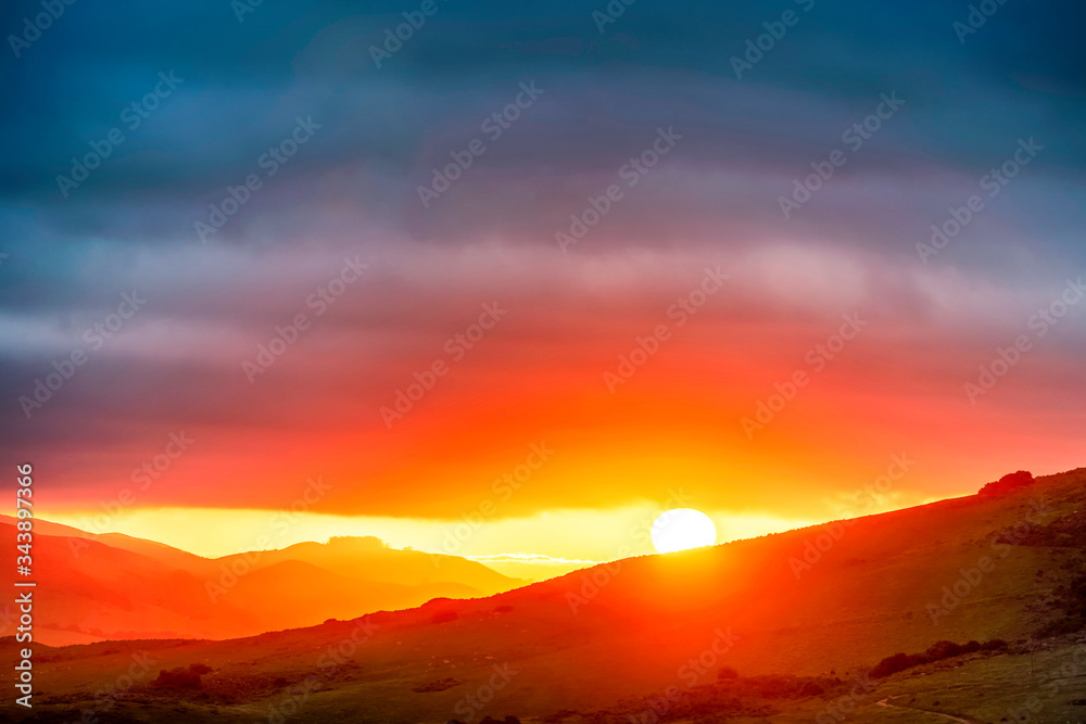 Sunset over the Mountains  with Clouds 