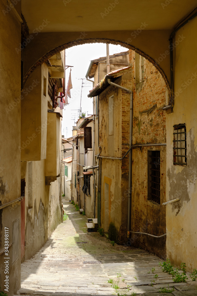 Narrow street in old little town Fucecchio. Solo Backpacker Trekking on the Via Francigena from Lucca to Siena. Walking between nature, history, churches,