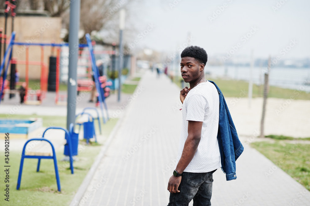 Young millennial african boy in city. Happy black man in jeans jacket. Generation Z concept. Young millennial african boy in city. Happy black man in jeans jacket. Generation Z concept.