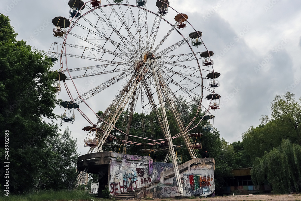 Abandoned city amusement park. Rusty Ferris Wheel.