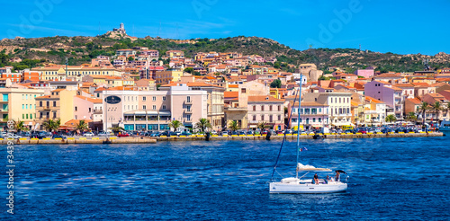 Panoramic view of La Maddalena old town quarter in Sardinia, Italy with port at the Tyrrhenian Sea coastline and island mountains interior in background photo