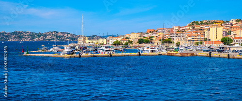 Panoramic view of La Maddalena old town quarter in Sardinia, Italy with port at the Tyrrhenian Sea coastline and island mountains interior in background © Art Media Factory