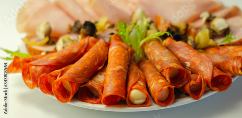 A cold plate prepared for the party with sliced chorizo, ham and sausages