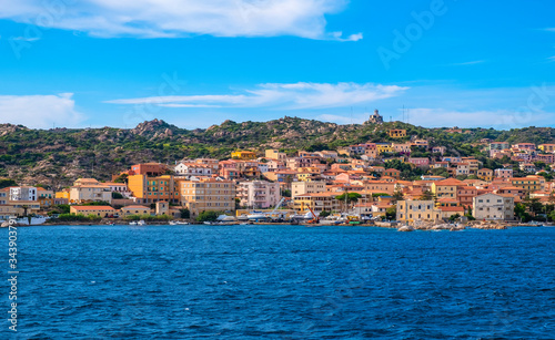 Panoramic view of La Maddalena old town quarter in Sardinia, Italy with port at the Tyrrhenian Sea coastline and island mountains interior in background photo
