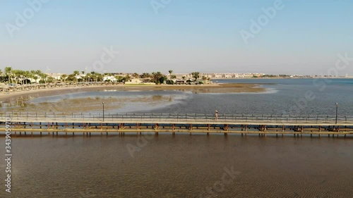 Wallpaper Mural Beautiful girl walks on the pier and enjoys the sea. Drone flight Torontodigital.ca