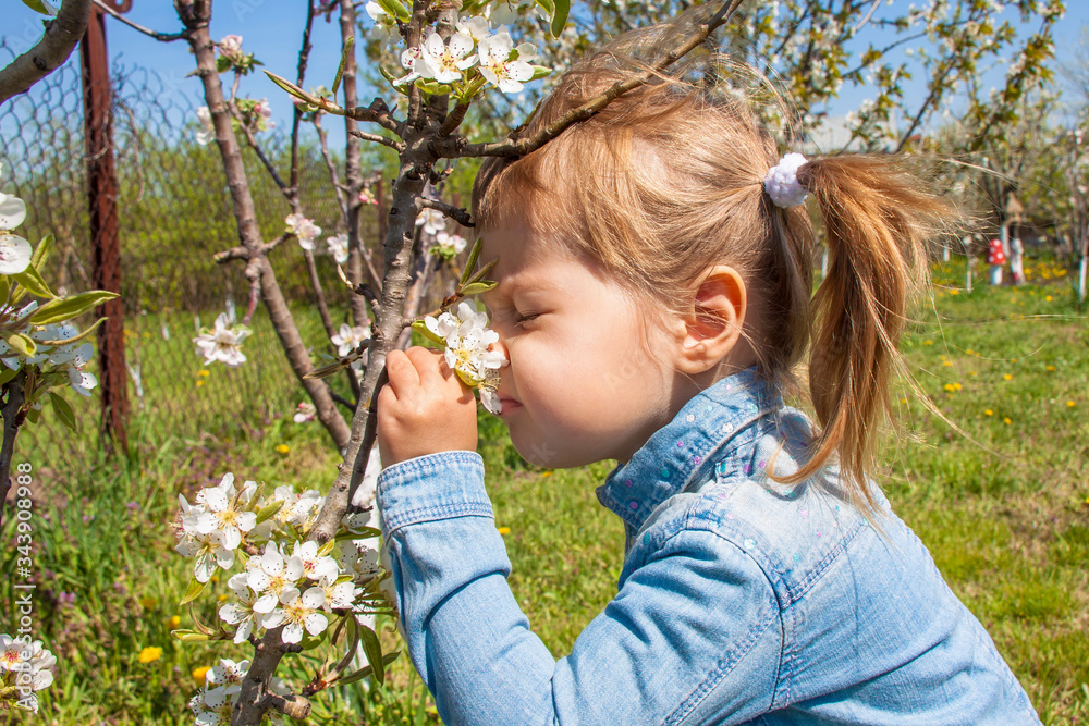 Little cute beautiful girl 3 years old sniffing flower Little cute beautiful girl 3 years old sniffing flower