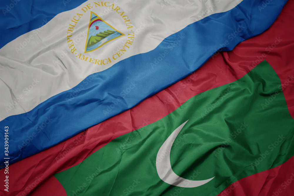 waving colorful flag of maldives and national flag of nicaragua. waving colorful flag of maldives and national flag of nicaragua.