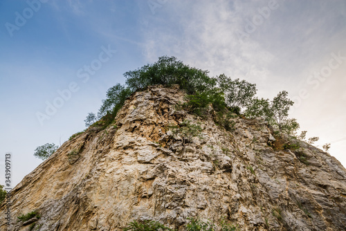 Rock mountain cliff and tree on the top isolated on white background. Beautiful Rock mountain in Khao Ngu Stone Park, Ratchaburi ,Thailand.