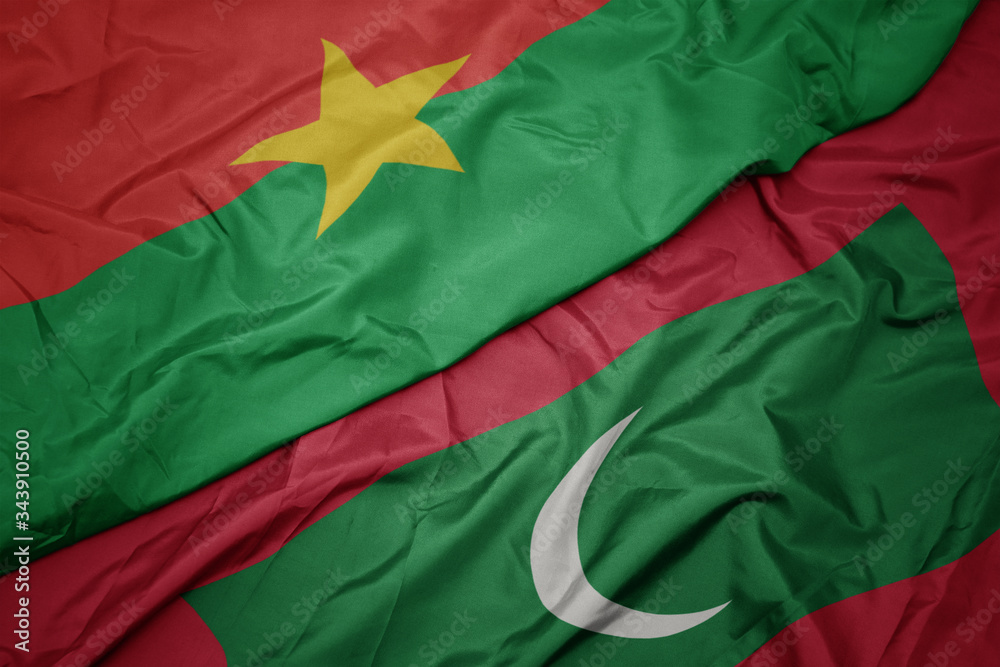 waving colorful flag of maldives and national flag of burkina faso.