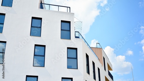 Contemporary residential building exterior in the daylight. Modern apartment buildings on a sunny day with a blue sky. Facade of a modern apartment building