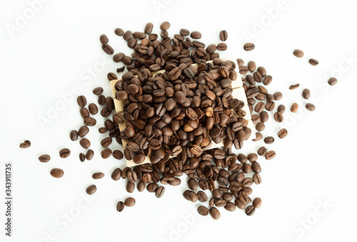 Coffee beans lying on on small wooden pallet