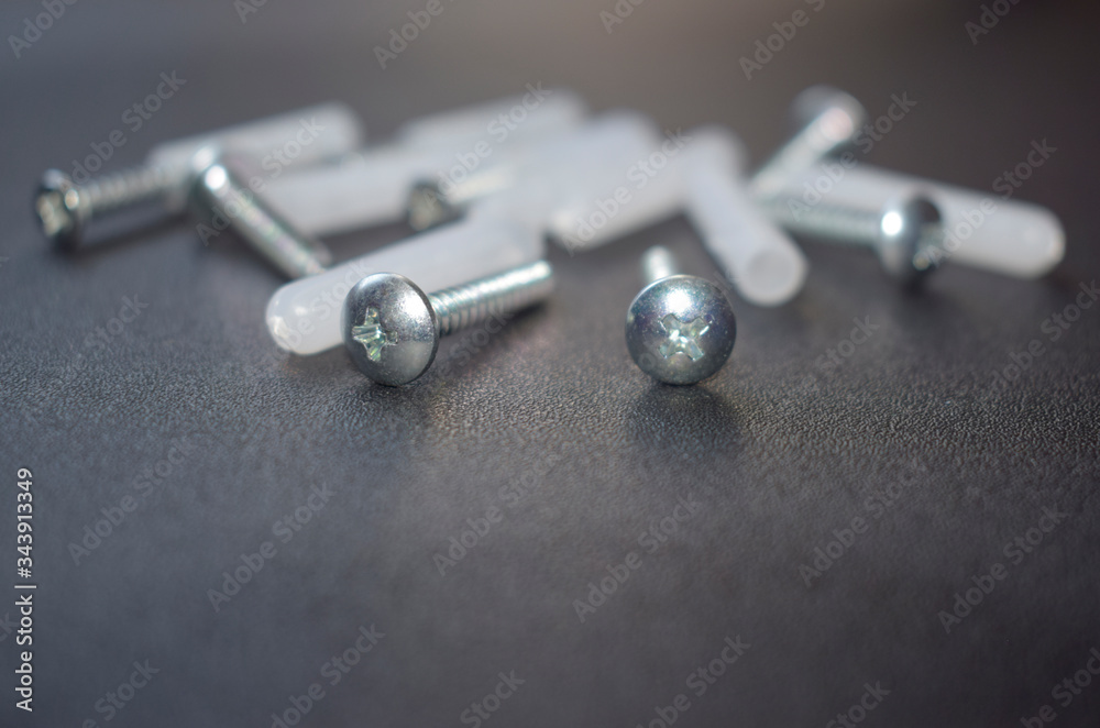 Dowels are randomly laid out on a black surface. Dowels are randomly laid out on a black surface.