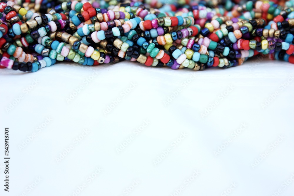 Multicolored small beads top view. Multicolored beads closeup with place for text. Multicolored beads top view. Abstraction of balls of different colors. Colorful bright background of small spheres.