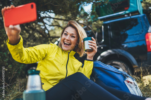 Girl joy showing teeth call on mobile phone in summer forest. Happy tourist communication take selfie on cellphone while traveling auto. Isolation woman using smartphone have fun emotion outdoors