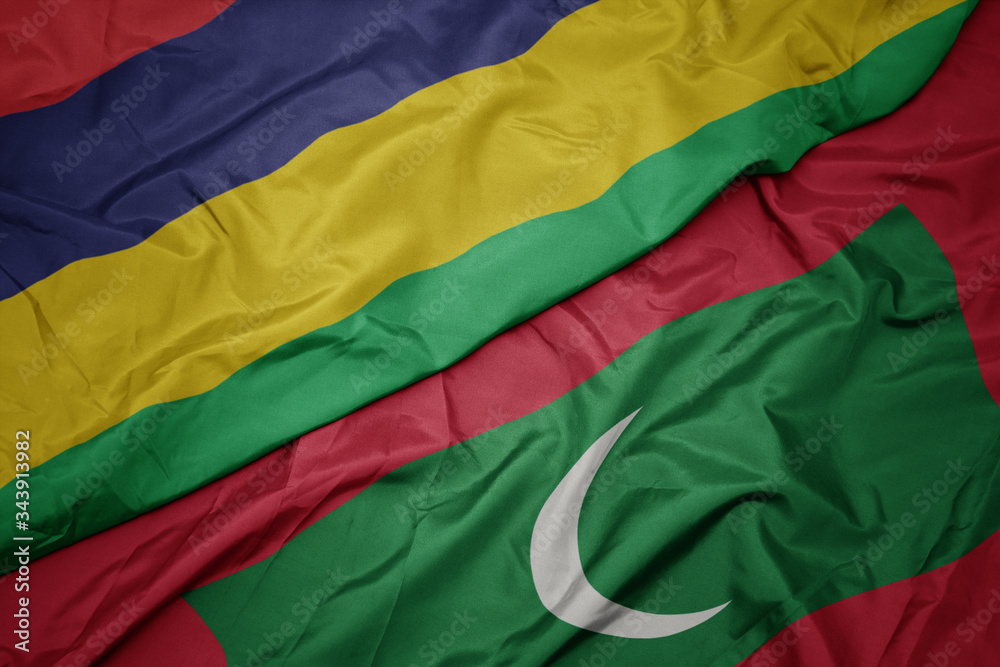 waving colorful flag of maldives and national flag of mauritius.