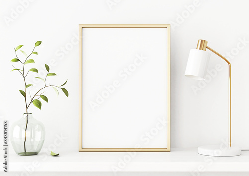 Interior poster mockup with vertical gold metal frame on the shelf with green tree branch in vase and desk lamp on empty white wall background. A4, A3 size format. 3D rendering, illustration.
