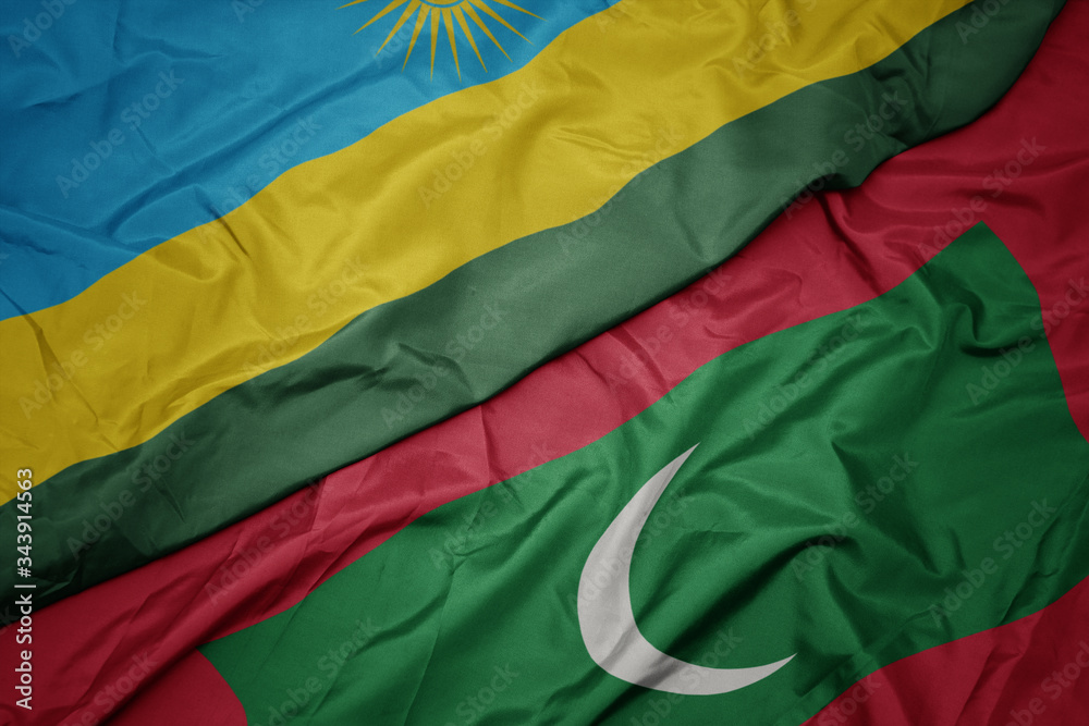 waving colorful flag of maldives and national flag of rwanda.