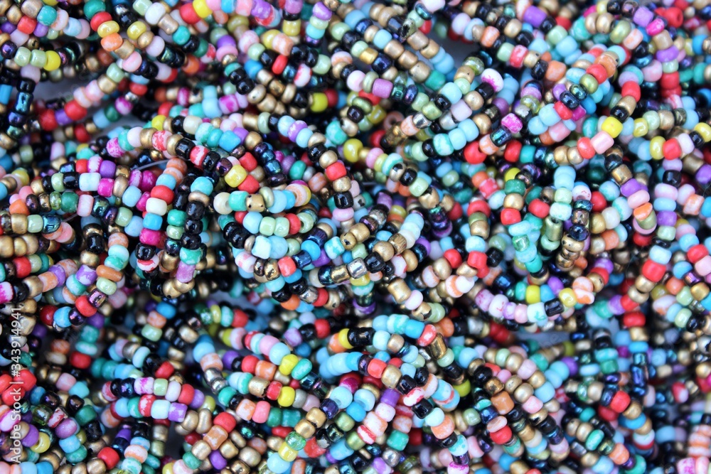 Multicolored small beads top view. Multicolored beads closeup with place for text. Multicolored beads top view. Abstraction of balls of different colors. Colorful bright background of small spheres.
