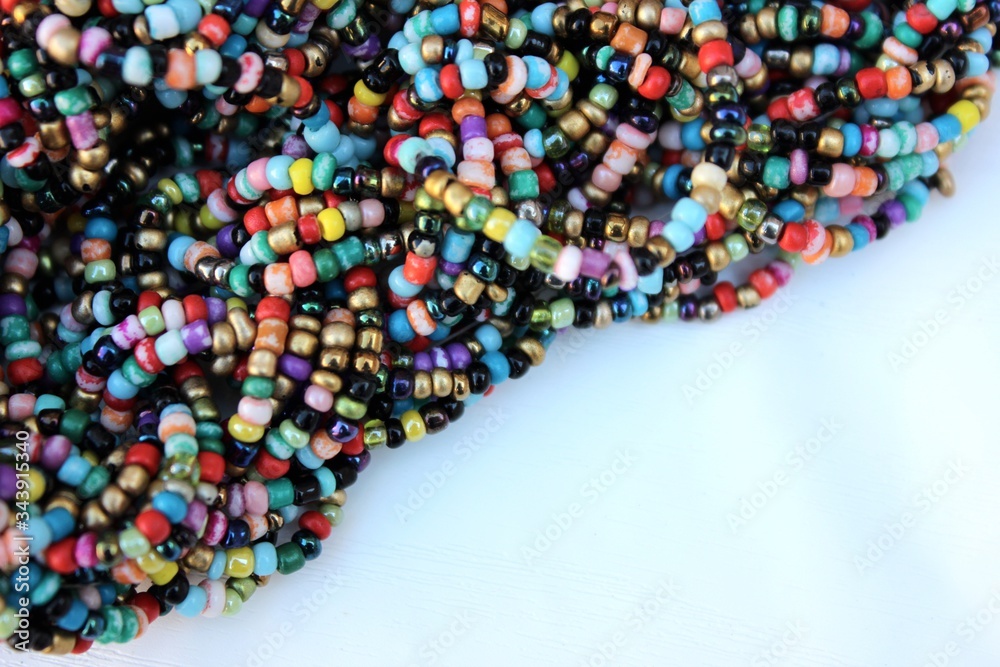 Multicolored small beads top view. Multicolored beads closeup with place for text. Multicolored beads top view. Abstraction of balls of different colors. Colorful bright background of small spheres.