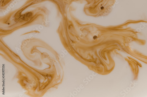 Brown stains in beige liquid with bubbles