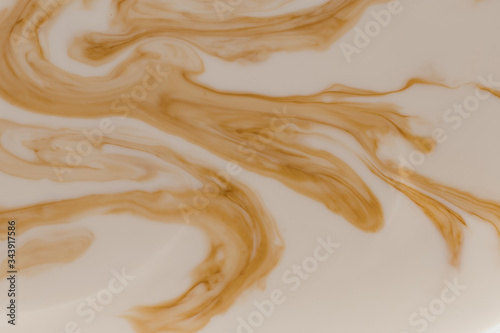 Fotografija Brown stains in beige liquid