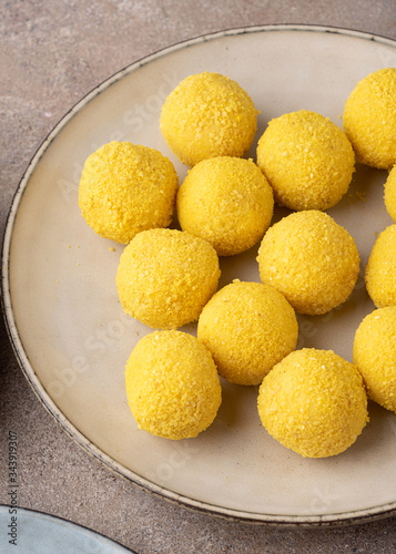 Mango and passion fruit truffles sprinkled with a mixture of turmeric extract and nut crumbs.