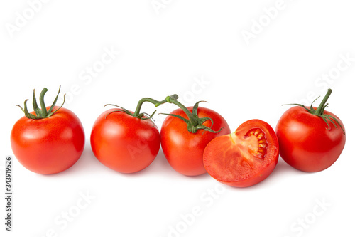 Several tomatoes on a white isolated background. Fresh vegetables.