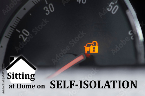 Concept - we’re not going anywhere by car "We are sitting at home on self-isolation." The yellow icon "Immobilizer Lock" on the dashboard of the car ...