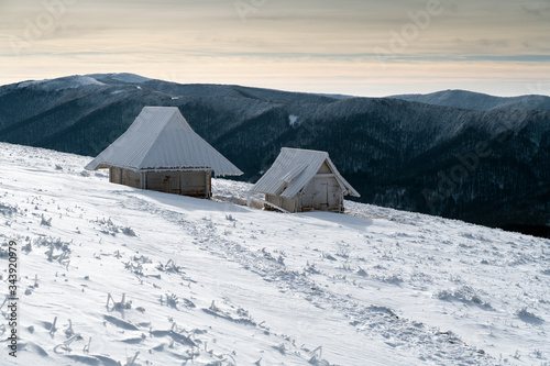 Fototapeta Naklejka Na Ścianę i Meble -  Frosty winter day in the Bieszczady Mountains. View of shepherd huts in  Polonina Wetlinska. Bieszczady National Park, Subcarpathian Voivodeship, Poland.