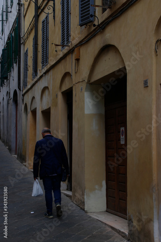 Old man walking in the street of Florence