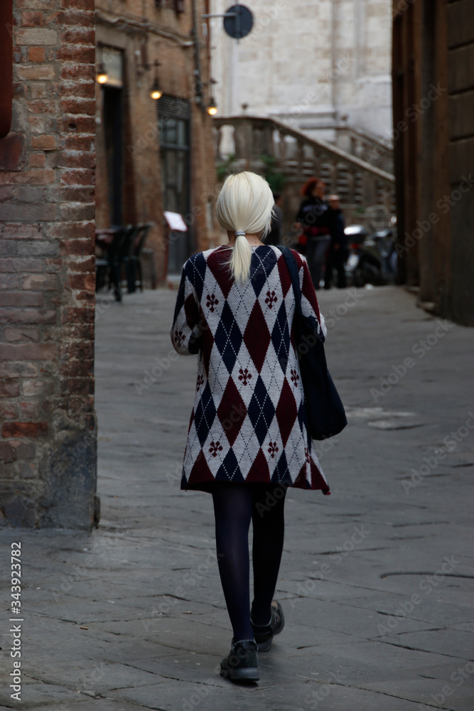 Blonde woman in a street of Siena