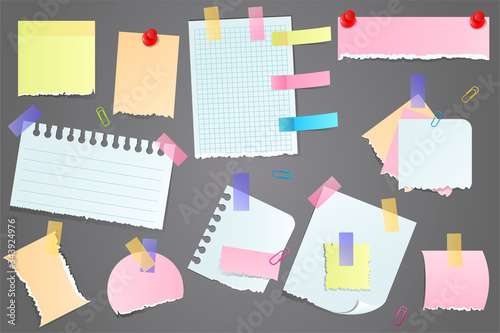 Collection of torn blank scraps of paper for memos, attached to a grey notice board with tape or thumb tacks in different colors and sizes with copy space.