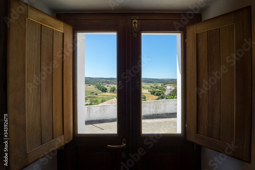View from a wooden door window inside a house on the countryside