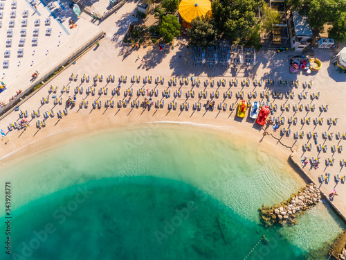 Aerial view of chairs on the shore of Poli Mora beach on sunny day in Crikvenica, Croatia.