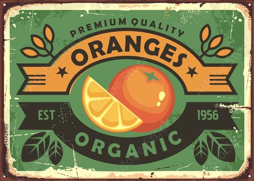 Oranges vintage sign. Organic fruit farm poster template with slice of orange, leaves and ribbons. Vector nostalgic banner.