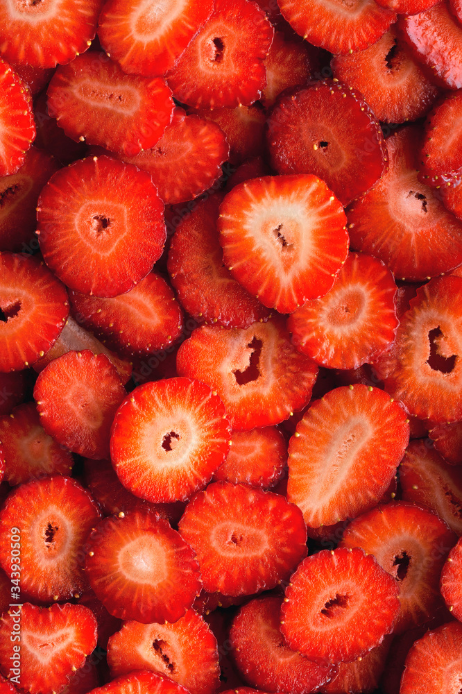 Sliced strawberry background and texture. Vertical photo. Sliced strawberry background and texture. Vertical photo.