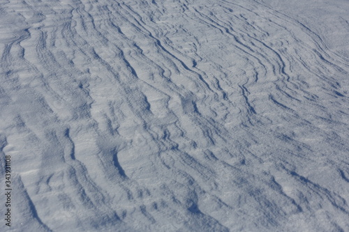 Snow crust. Snowy texture. Gray background.