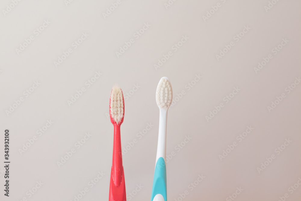 Red and blue toothbrushes on a gray background. Old and new toothbrush. Oral hygiene concept. copy space for text Red and blue toothbrushes on a gray background. Old and new toothbrush. Oral hygiene concept. copy space for text