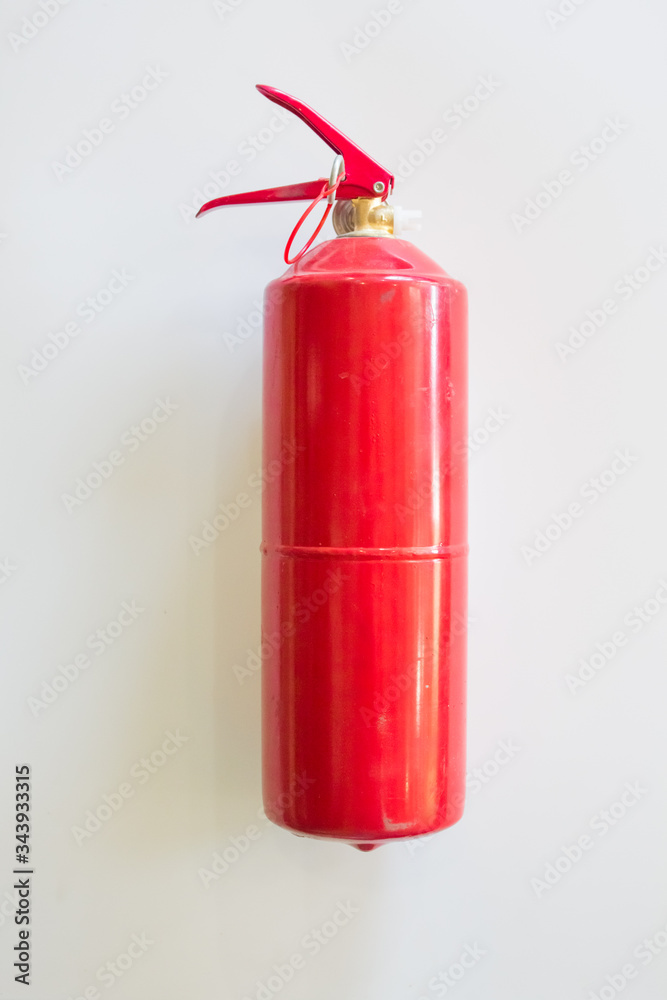 fire extinguisher on a white wall background. fire concept fire extinguisher on a white wall background. fire concept
